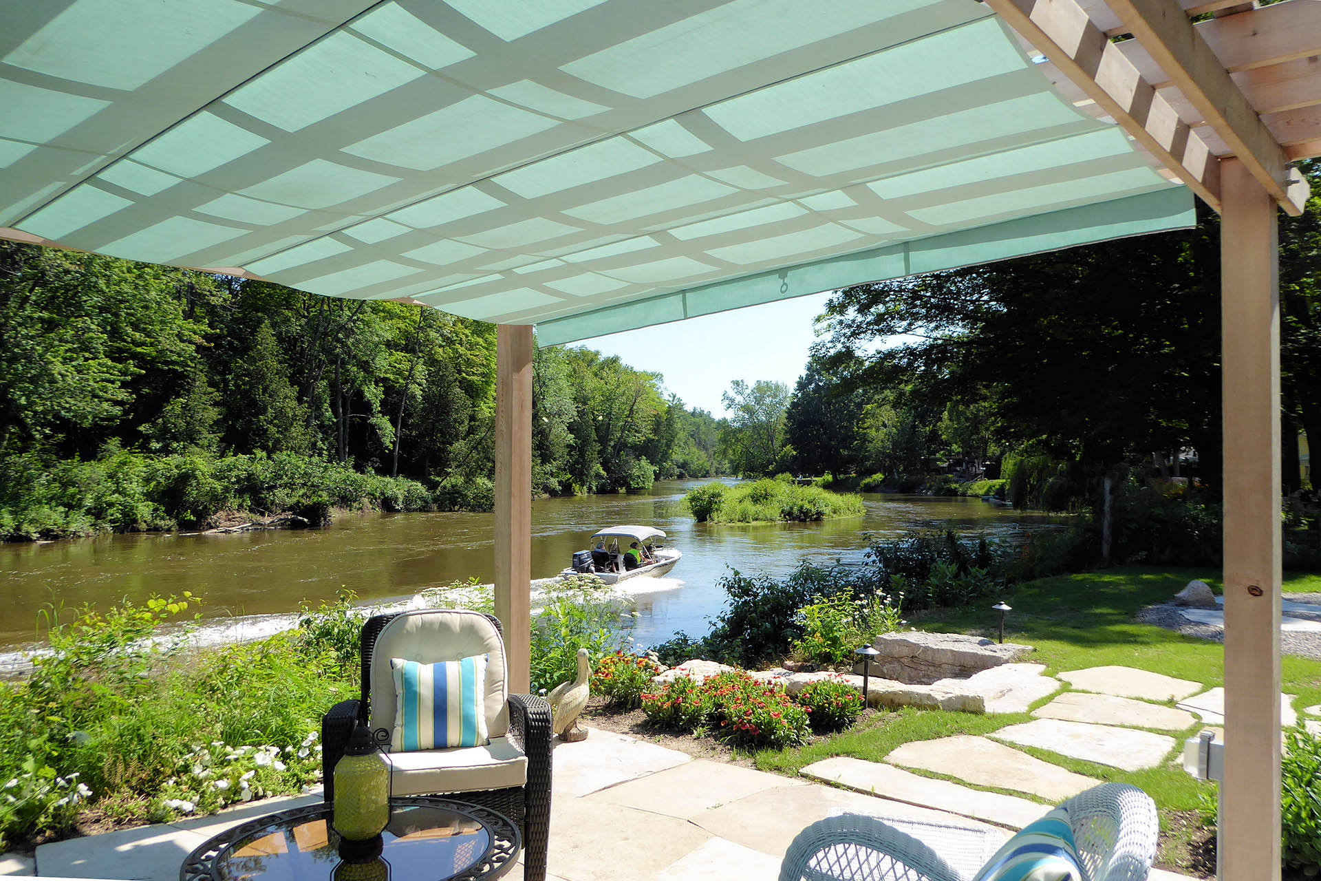 a blue retractable canopy on a pergola in Wasaga Beach